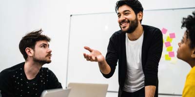 Team leader motivating colleagues in a meeting